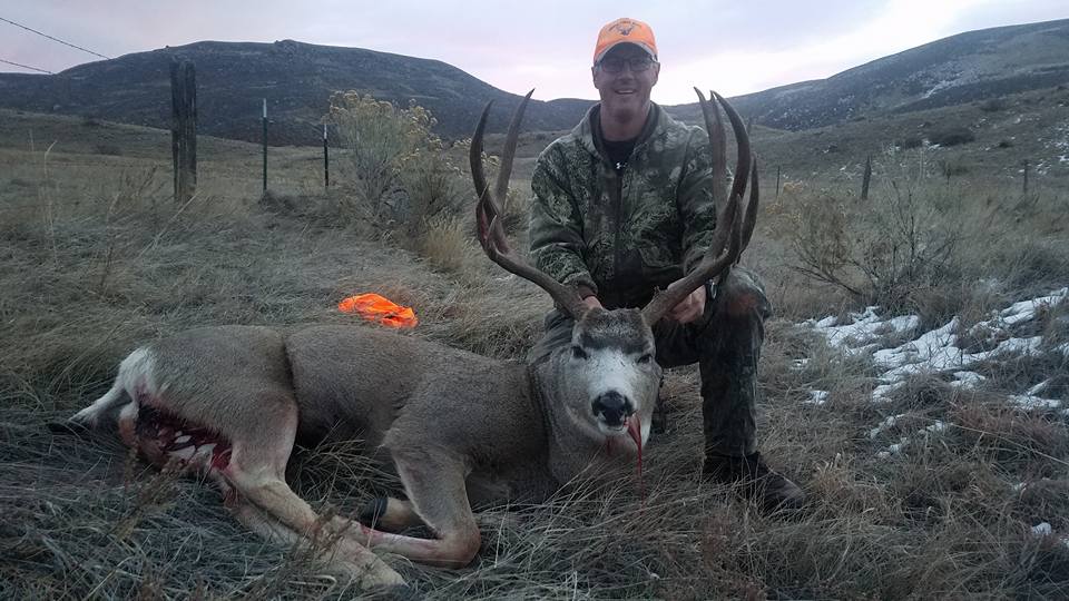 Hunter with a captured elk